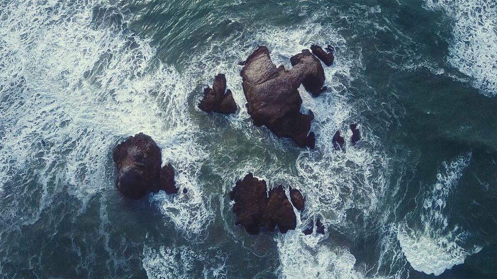 Waves striking stones in the ocean
