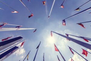 Flagpoles of the United Nations photographed from below in a circle.